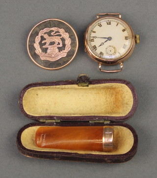 A yellow 9ct gold wristwatch, a tortoiseshell brooch and a cased cheroot holder