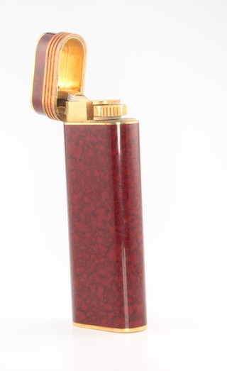 A lady's Must De Cartier gilt lacquered cigarette lighter, boxed and with paper work 