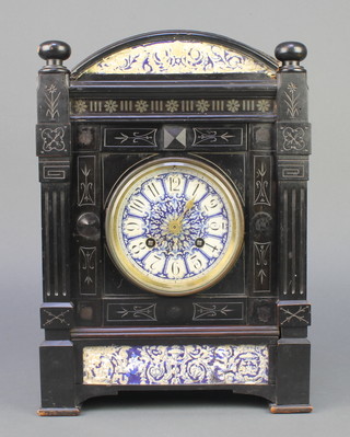 An 8 day striking mantel clock with blue and white porcelain dial, Arabic numerals, contained in an ebonised case 