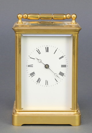 A 19th Century French 8 day striking carriage clock with enamelled dial and Roman numerals, contained in a gilt metal case 5"h x 3" x 3" 