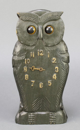 A 1930's Continental timepiece in the form of a standing owl with moving eyes indicating seconds, Arabic numerals contained in a carved wooden case 9 1/2" 