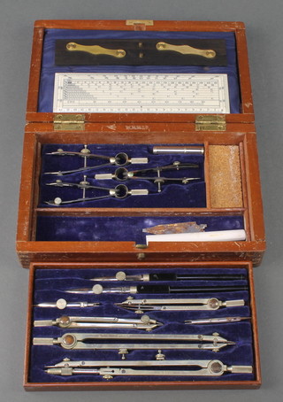 A chrome geometry set marked WHH Ltd. with ebonised parallel rule and gauge all marked with a broad arrow contained in a mahogany box with hinged lid 

