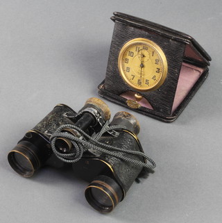 A pair of Bausch & Lomb military Stereo 6 x 39 field glasses together with an 8 day travelling clock retailed by J Bosecke & Co. Ltd Calcutta 