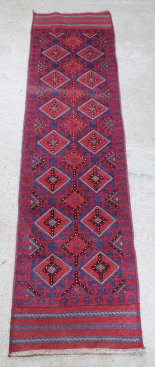 A red and blue ground Meshwani runner with numerous diamonds to the centre 105" x 25"