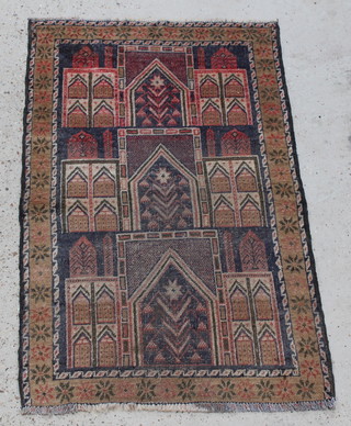 A Persian black and brown ground rug with panel decoration, some wear, 54" x 34"