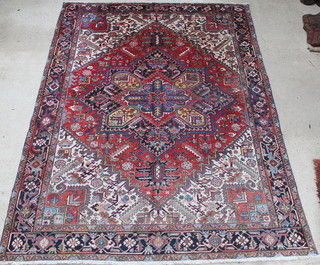 A Persian red, blue and white ground Heriz carpet with stylised diamond to the centre 142" x 109" 