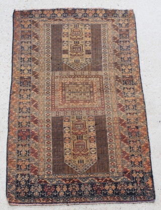 A brown ground Belouche rug with rectangular medallion to the centre within multi row borders 56" x 36" 