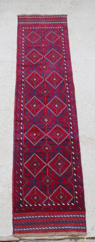 A red and blue Meshwani runner with 14 diamonds to the centre 105" x 24" 