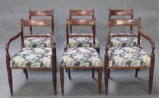 A set of 6 Regency carved mahogany bar back dining chairs with over stuffed seats, raised on tapered supports  