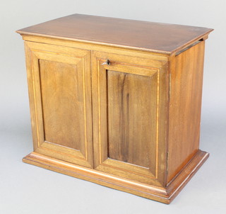 An Edwardian inlaid mahogany smoker's cabinet with hinged lid, fitted 2 drawers and a pipe receptacle enclosed by panelled doors 13"h x 15"w x 9 1/2"d 