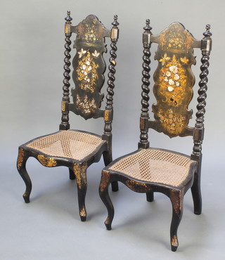 A pair of Victorian black lacquered and inlaid mother of pearl slat back nursing chairs with spiral turned columns to the side and woven cane seats of serpentine outline, raised on cabriole supports 
