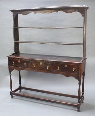 An 18th Century style oak dresser, the back with two shelves and moulded cornice, the base fitted 3 long drawers with brass pear drop handles and raised on turned supports 74"h x 60"w x 16 1/2"d