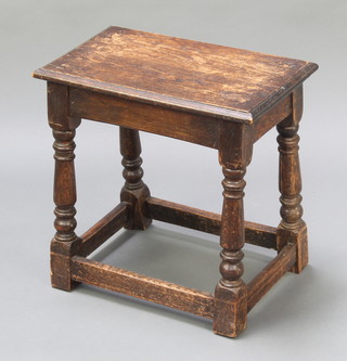 A rectangular oak joined stool raised on turned and block supports 18"h x 18"w x 11"d