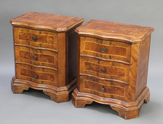 A pair of Queen Anne style walnut bedside chests of serpentine outline with crossbanded tops fitted 3 long drawers, raised on shaped platform bases 24"h x 20"w x 13 1/2d
