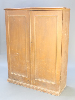 A Victorian pine "land agents" filing cabinet with moulded cornice, fitted 18 long drawers with brass countersunk handles enclosed by a pair of panelled doors, raised on a platform base 64"h x 50"w x 18"d 