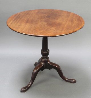 A circular Georgian mahogany snap top tea table raised on gun barrel turned column tripod supports 27 1/2"h x 31" diam. 