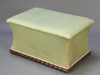 A Victorian ottoman of waisted form upholstered in green material, raised on bun feet 19"h x 36"w x 24" 