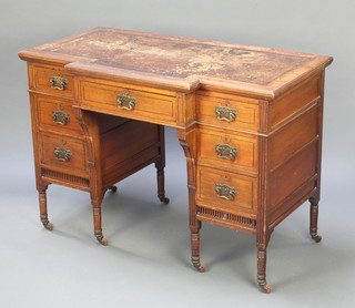An Edwardian walnut breakfront carved writing table with inset brown leather writing surface above 1 long and 6 short drawers with brass swan neck drop handles, raised on turned supports 29 1/2"h x 42"w x 24"d  