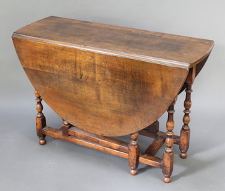 A 17th Century style oak oval gateleg drop flap dining table on turned supports 29 1/2"h x 42 1/2"w x 17" when closed x 56" when open 