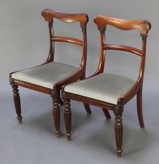 A pair of Victorian rosewood bar back dining chairs with plain mid rails and upholstered drop in seats on turned and reeded supports 