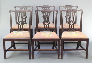 A set of 6 19th Century Chippendale style mahogany dining chairs with carved pierced vase shaped slat backs and upholstered drop in seats, raised on square tapering supports 