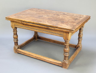 A rectangular oak draw leaf dining table with carved apron raised on turned and block supports with box framed stretcher 30"h x 54"w x 86 1/2" with leaves 