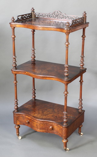 A Victorian 3 tier figured walnut what-not with pierced three-quarter gallery, the base fitted 1 long drawer, raised on brass caps and ceramics casters 48"h x 23"w x 14"d 