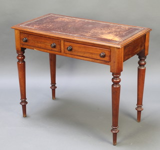 A Victorian rectangular mahogany writing table with tooled leather writing surface, fitted 2 drawers and raised on turned supports 29 1/2"h x 35"w x 19 1/2"d 