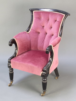 A William IV ebonised show frame tub back armchair upholstered in purple dralon, raised on turned and reeded supports, brass caps and casters 