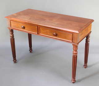 A Victorian rectangular mahogany side table fitted 2 frieze drawers with tore handles, raised on turned and reeded supports 30"h x 44 1/2"w x 21"d 