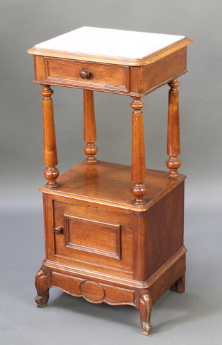 A French walnut pot cabinet with white veined marble top, fitted a drawer above a recess, the base enclosed by a panelled door, raised on cabriole supports 34"h x 16"w x 14"d 