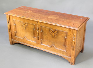 A light oak Jacobean style coffer with hinged lid and geometric mouldings 19"h x 42"w x 16"d 