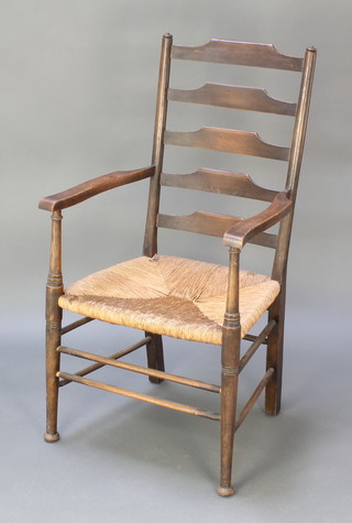 An elm ladder back carver chair with woven rush seat on club supports 