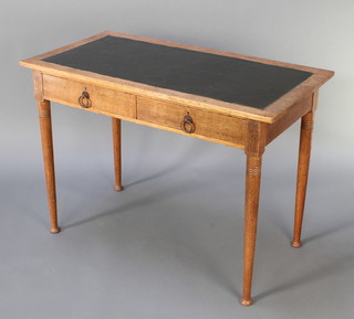 S J Waring, an Art Nouveau light oak writing table with inset writing surface, fitted 2 drawers raised on turned supports 30"h x 42"w x 21"d 