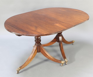 A Georgian style mahogany oval dining table with 1 extra leaf, raised on twin pillar and tripod supports 29"h x 39"w x 59" when fully extended 80 1/2" 