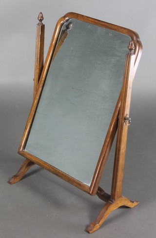 A Queen Anne style arched plated dressing table mirror contained in a walnut swing frame 22 1/2" x 15" 