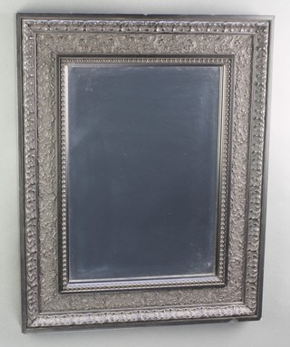 A rectangular bevelled plate wall mirror contained in a decorative ebonised frame 26" x 20" 