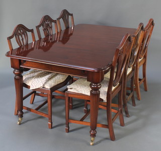 A mahogany dining room suite comprising Victorian style rectangular extending dining table raised on turned and reeded supports with brass caps and castors 30"h x 40"w x 72"l x 93"l when extended, together with  set of 6 Hepplewhite style camel back dining chairs with upholstered drop in seats, raised on square tapering supports 