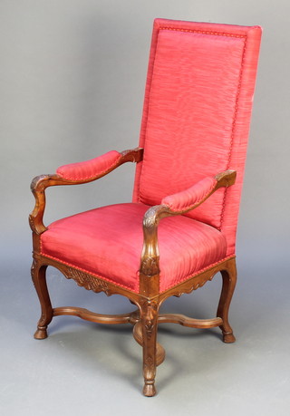 An Italian style carved walnut high back open arm chair raised on cabriole hoof supports with X framed stretcher 