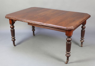 A Victorian mahogany extending dining table raised on turned and reeded supports 28 1/2"h x 40"w x 44"l x 58 1/2" when extended 