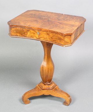 A Victorian shaped mahogany work table with three quarter veneered top, the hinged lid revealing a fitted interior, raised on a turned column and chamfered base 29"h x 20 1/2" x 16 1/2" 