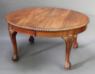 An Edwardian Chippendale style mahogany dining room suite comprising oval extending dining table with 1 extra leaf and with gadrooned border 28"h x 42"w x 53"l x 71"l when extended, together with a set of 6 dining chairs with vase shaped slat backs and upholstered drop in seats, raised on cabriole ball and claw supports