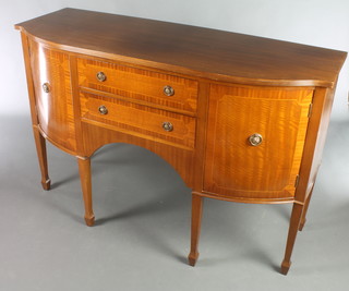 A Georgian style bow front mahogany sideboard fitted 3 drawers flanked by a pair of cupboards, raised on square tapering supports ending in spade feet 36"h x 55"w x 20 1/2"d 