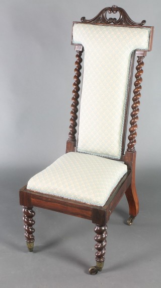 A Victorian rosewood show frame nursing chair upholstered in blue material raised on spiral turned supports