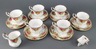 A Royal Albert Old Country Roses part tea set comprising 6 tea cups, 6 saucers, 6 side plates, cream jug and a wheel barrow 