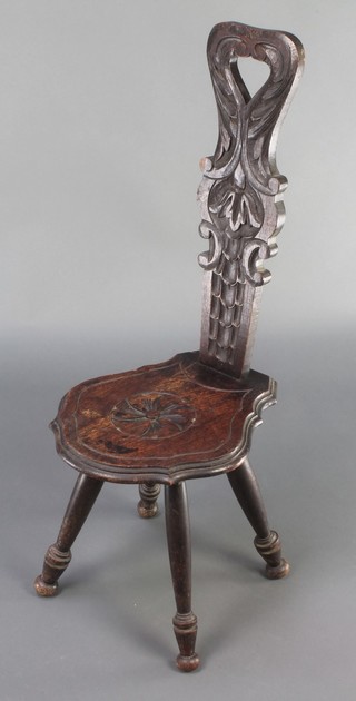 A Victorian carved oak spinning chair with solid seat and back, raised on turned supports 