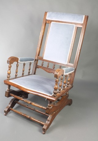 A 19th Century American rocking chair upholstered in light blue Dralon 