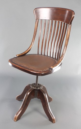 An Edwardian mahogany stick and bar back adjustable revolving office chair  