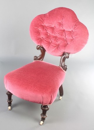 A Victorian oak and iron framed nursing chair upholstered in pink buttoned Dralon 
