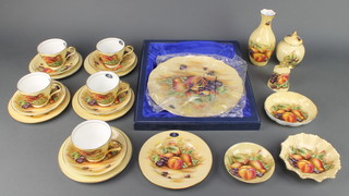 An Aynsley Orchard Gold part tea set comprising 5 tea cups, 5 saucers, a baluster vase, a baluster jar and cover, a bell, 3 dishes, a cake plate and knife 